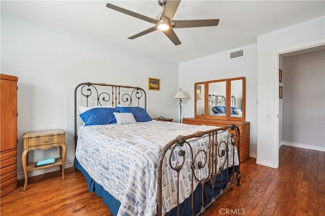 bedroom with visible vents, baseboards, ceiling fan, and wood finished floors