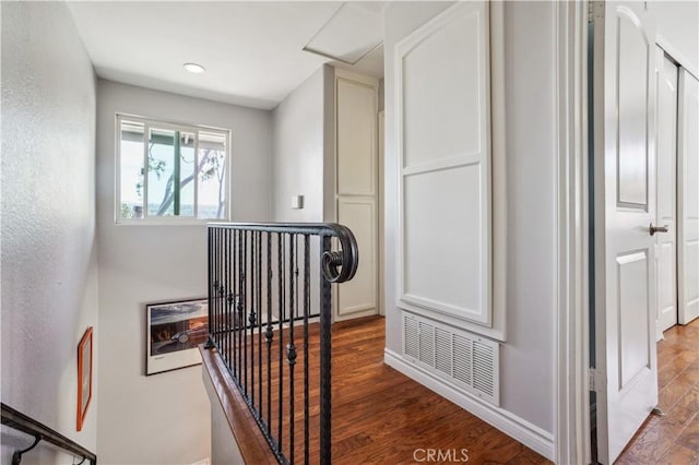 stairs with baseboards, recessed lighting, wood finished floors, and visible vents