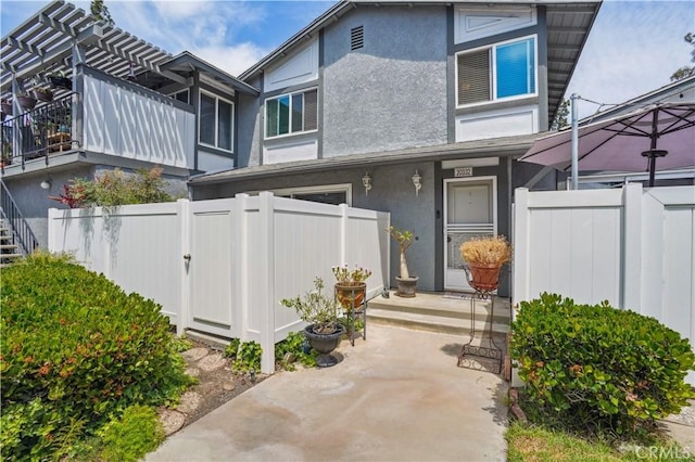 20332 Flower Gate Ln Unit 7, Yorba Linda, CA 92886 - doorway to property featuring stucco siding and fence