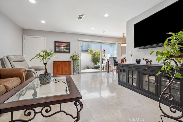 living room featuring recessed lighting and visible vents
