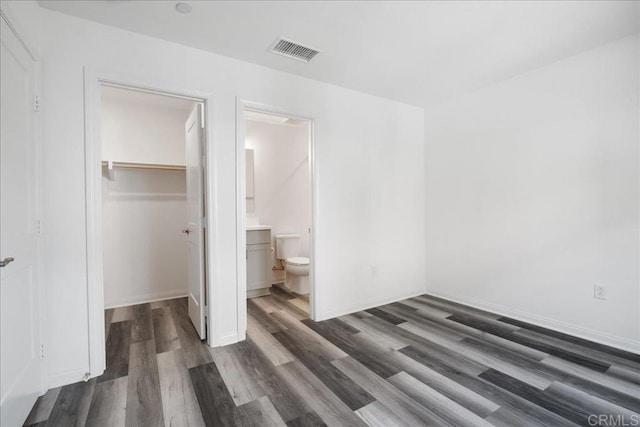 1524 Redbud Way, Oceanside, CA 92056 - unfurnished bedroom with dark wood-style flooring, a walk in closet, baseboards, visible vents, and a closet