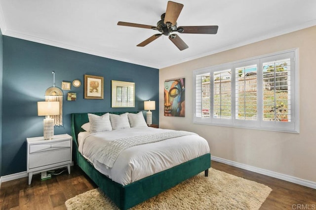 bedroom with crown molding, baseboards, ceiling fan, and wood finished floors