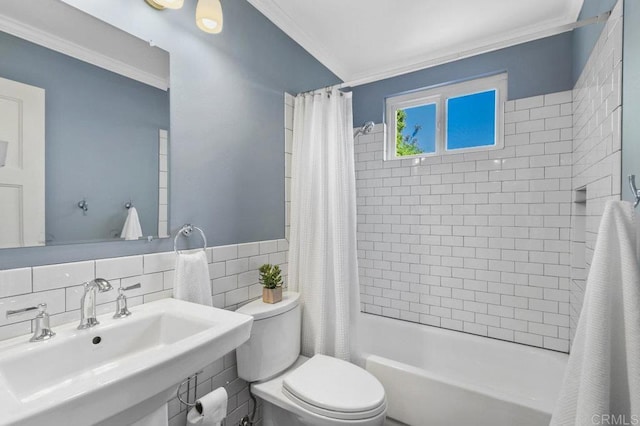 bathroom featuring toilet, tile walls, ornamental molding, and a sink