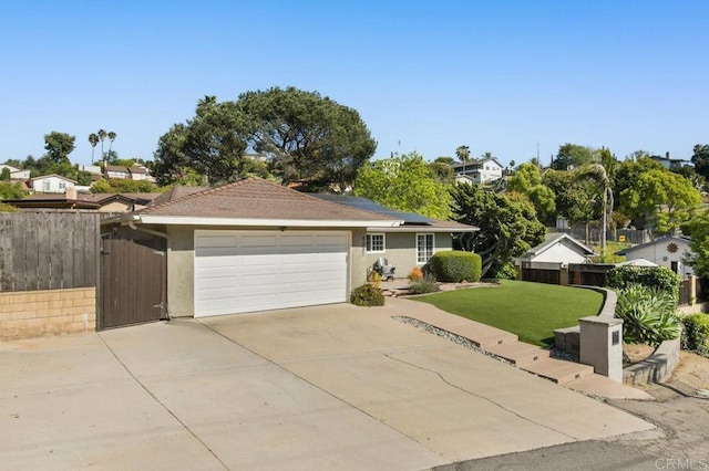 ranch-style home with a front lawn, a garage, stucco siding, concrete driveway, and solar panels