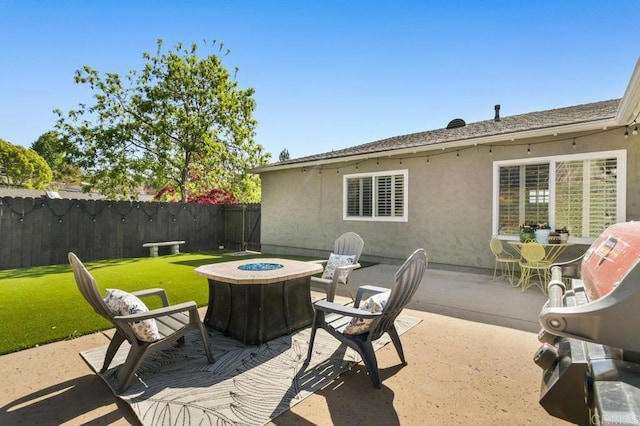 view of patio / terrace featuring fence and a fire pit