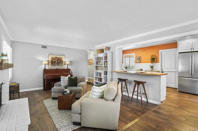 living room with visible vents, ornamental molding, a wealth of natural light, and dark wood-style floors