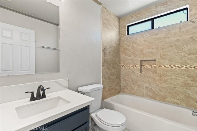 full bathroom featuring toilet, tub / shower combination, and vanity
