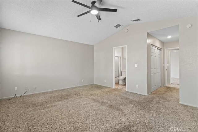 unfurnished bedroom featuring carpet floors, a textured ceiling, and visible vents