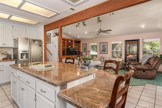 36556 Mudge Ranch Rd, Coarsegold, CA 93614 - kitchen featuring visible vents, light tile patterned flooring, open floor plan, stainless steel refrigerator with ice dispenser, and vaulted ceiling