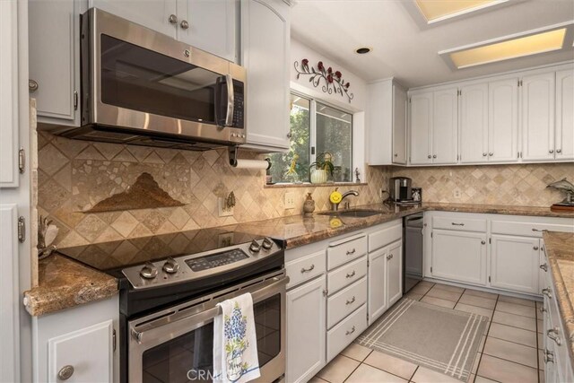 36556 Mudge Ranch Rd, Coarsegold, CA 93614 - kitchen with backsplash, white cabinetry, appliances with stainless steel finishes, and a sink