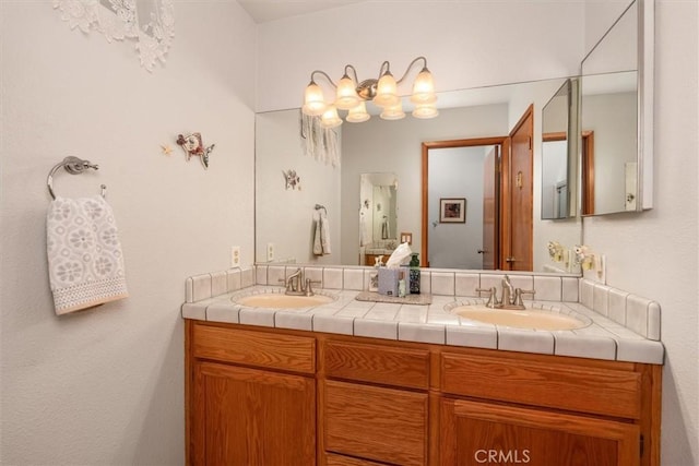36556 Mudge Ranch Rd, Coarsegold, CA 93614 - bathroom featuring double vanity, a sink, and an inviting chandelier
