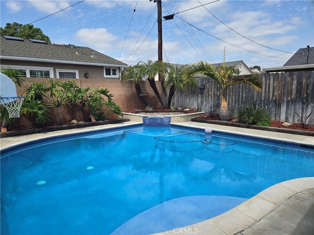 view of swimming pool with a fenced backyard and a fenced in pool