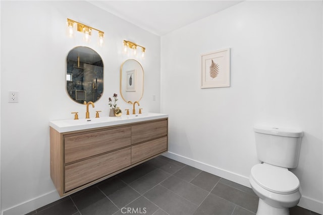 6316 Michelson St, Lakewood, CA 90713 - full bathroom with baseboards, double vanity, tile patterned flooring, and toilet