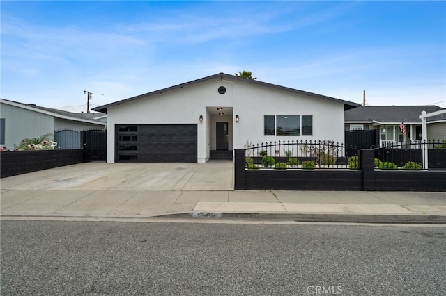 6316 Michelson St, Lakewood, CA 90713 - view of front of property with an attached garage, a fenced front yard, stucco siding, and driveway