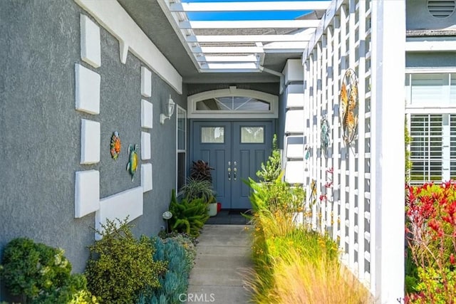 doorway to property with stucco siding