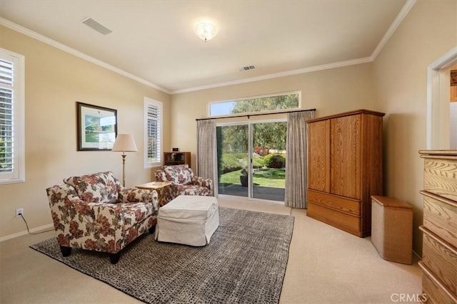 sitting room with light colored carpet, a healthy amount of sunlight, and visible vents