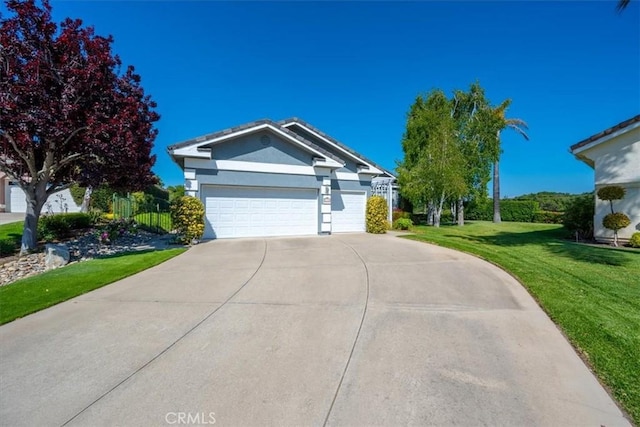 ranch-style home featuring a garage, a front lawn, stucco siding, and concrete driveway
