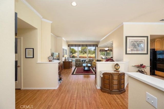 interior space with baseboards, ornamental molding, and light wood-style flooring