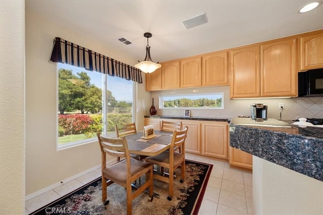 dining area featuring visible vents, baseboards, and light tile patterned floors