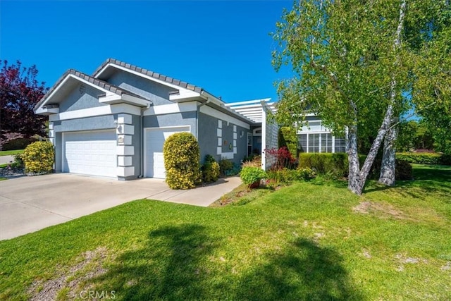 single story home featuring an attached garage, a front lawn, stucco siding, and concrete driveway