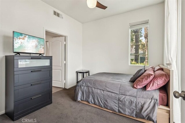 carpeted bedroom featuring a ceiling fan and visible vents