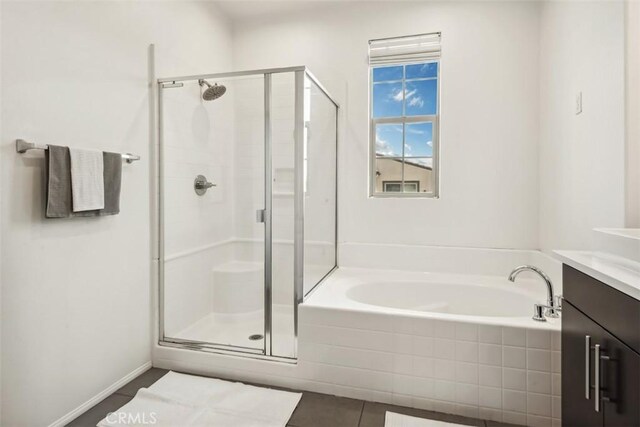 full bathroom with tile patterned floors, a shower stall, a bath, and vanity