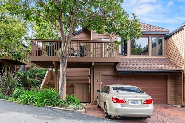 672 Serrano Dr Unit 9, San Luis Obispo, CA 93405 - view of property featuring roof with shingles, an attached garage, driveway, and stairway