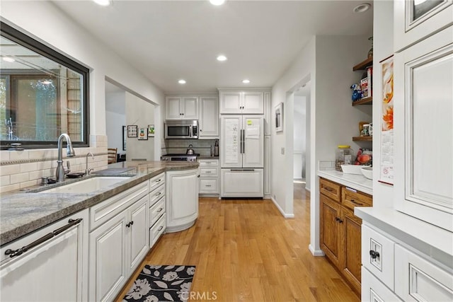 672 Serrano Dr Unit 9, San Luis Obispo, CA 93405 - kitchen with built in refrigerator, stainless steel microwave, a sink, tasteful backsplash, and white cabinetry