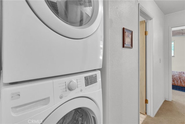 2664 Pine Ridge Rd, Bradley, CA 93426 - laundry area featuring stacked washer / dryer and light colored carpet