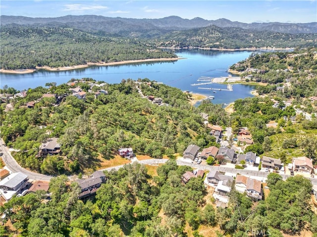 bird's eye view featuring a water and mountain view and a wooded view