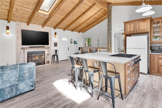 kitchen featuring freestanding refrigerator, wood ceiling, beam ceiling, and light wood-style flooring