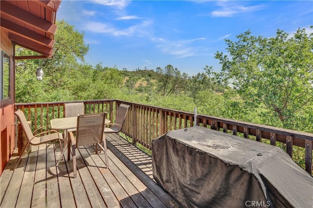 wooden terrace with outdoor dining area