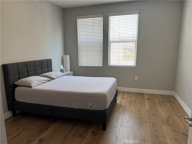 12842 Palm St Unit 108, Garden Grove, CA 92840 - bedroom featuring baseboards and light wood-style floors