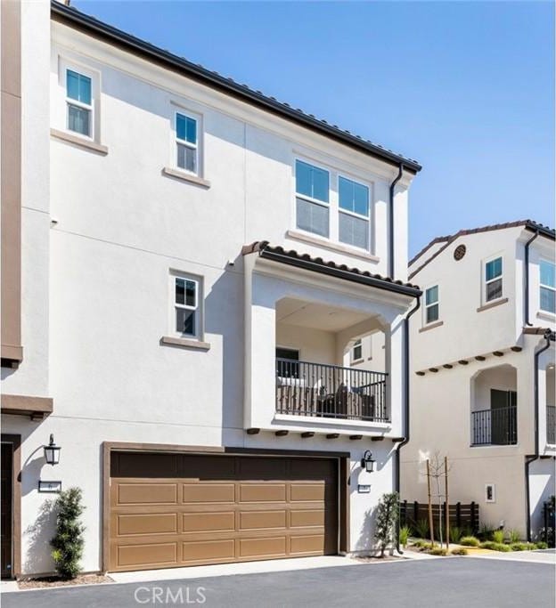 view of front of home with a garage and stucco siding