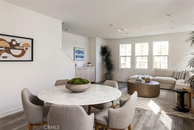 dining space with visible vents, recessed lighting, baseboards, and wood finished floors