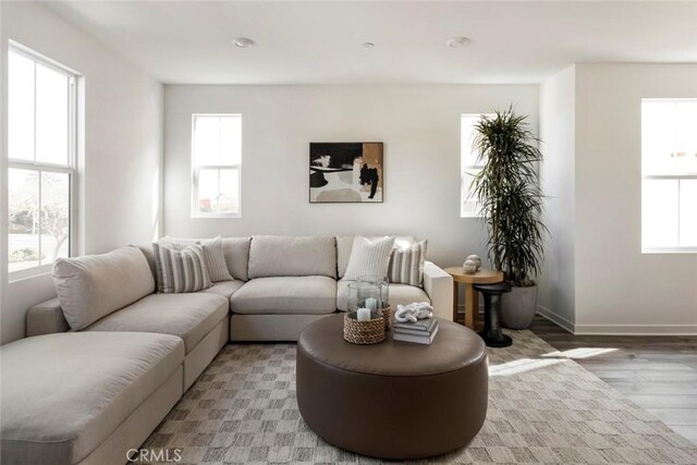 living area with baseboards and light wood-style floors