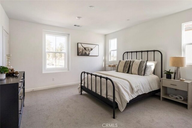 carpeted bedroom with baseboards and visible vents