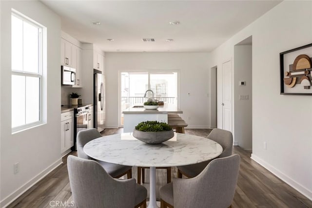 15216 Janine Dr Unit 7, Whittier, CA 90605 - dining area featuring visible vents, a healthy amount of sunlight, and dark wood-type flooring