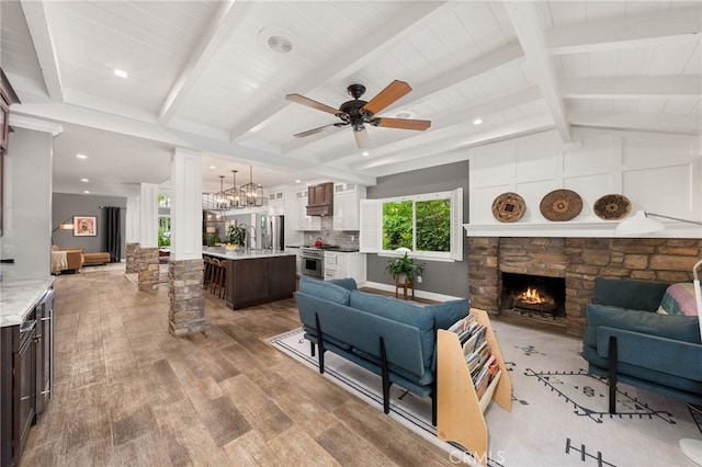324 W S Ave, Redlands, CA 92373 - living area with wood finished floors, a stone fireplace, ceiling fan, decorative columns, and recessed lighting