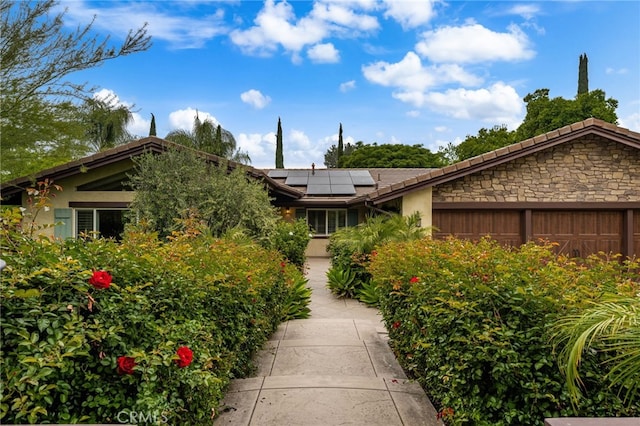 324 W S Ave, Redlands, CA 92373 - view of front facade featuring solar panels, stucco siding, and a tiled roof