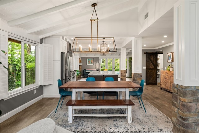 324 W S Ave, Redlands, CA 92373 - dining room with wood finished floors, healthy amount of natural light, a barn door, a chandelier, and crown molding