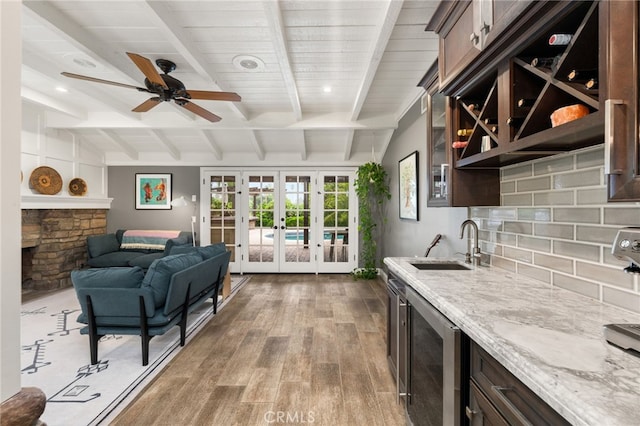 324 W S Ave, Redlands, CA 92373 - kitchen with beverage cooler, wood finished floors, light stone countertops, a ceiling fan, and tasteful backsplash
