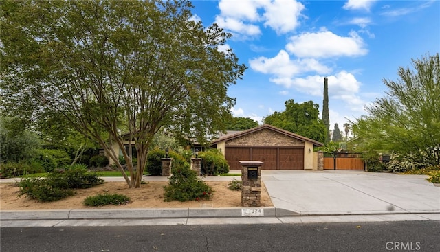324 W S Ave, Redlands, CA 92373 - view of front of house featuring driveway, an attached garage, stucco siding, and stone siding