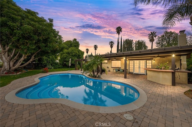 324 W S Ave, Redlands, CA 92373 - pool at dusk with french doors, a patio area, an outdoor pool, and a pergola