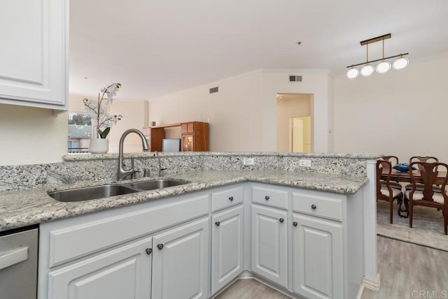 10832 Scripps Ranch Blvd Unit 307, San Diego, CA 92131 - kitchen featuring white cabinets, ornamental molding, a sink, and light wood-type flooring