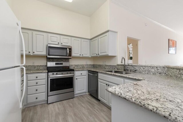 10832 Scripps Ranch Blvd Unit 307, San Diego, CA 92131 - kitchen with crown molding, light stone countertops, a sink, stainless steel appliances, and light wood-type flooring
