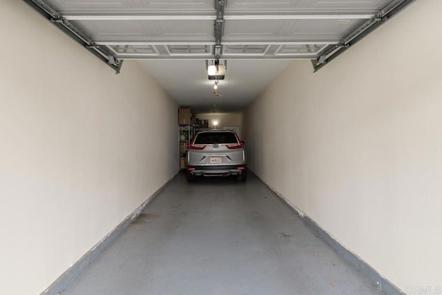 10832 Scripps Ranch Blvd Unit 307, San Diego, CA 92131 - garage featuring baseboards and a garage door opener
