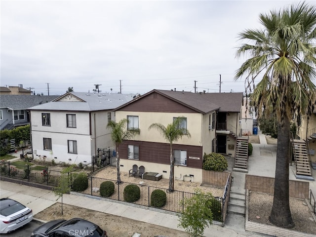 7347 Bakman Ave, Sun Valley, CA 91352 - view of property with stairs, a fenced front yard, stucco siding, and a patio area