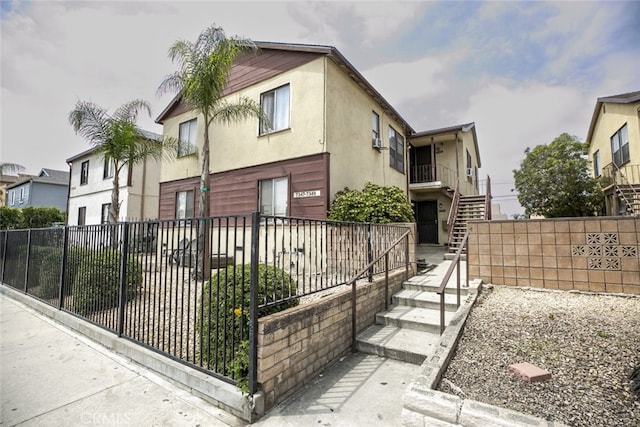 7347 Bakman Ave, Sun Valley, CA 91352 - view of front facade with stucco siding, fence private yard, and stairway