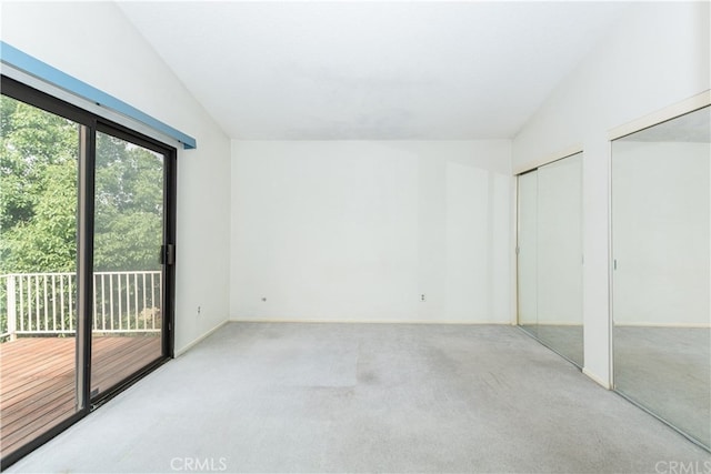 3899 28th St, Highland, CA 92346 - unfurnished bedroom featuring multiple closets, access to exterior, carpet flooring, and lofted ceiling